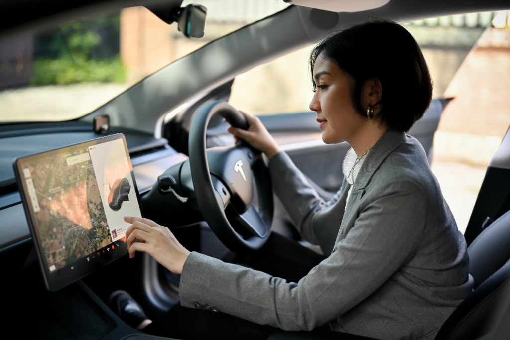 A Tesla-driver using a Tesla touchscreen user interface like a phone